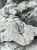 Silver signet ring with Picasso dolomite on natural rock background.