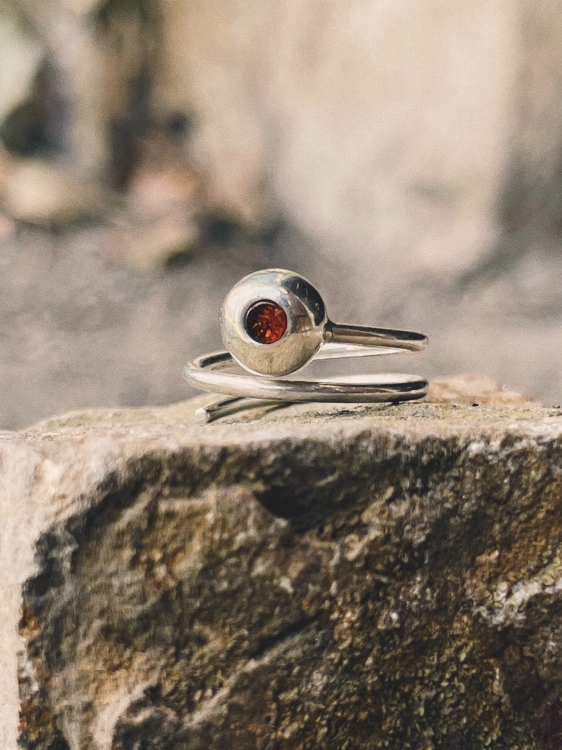 Handcrafted silver spiral ring with amber accent