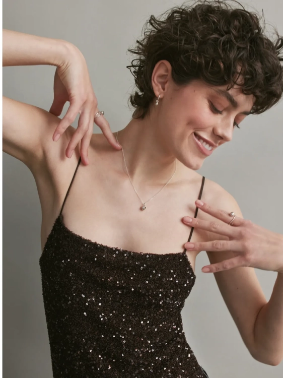 Minimal sterling silver necklace with sphere decorated with amber worn by model