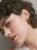 Gold-plated ear cuff with spherical design worn on the ear