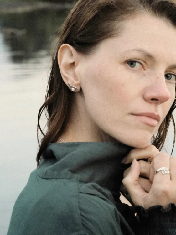 Wave-inspired silver earrings with milky amber in a subtle form