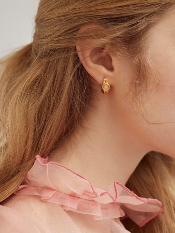 Gold-plated hoop earrings with mountain crystal worn on the ear