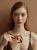 Gold-plated amber necklace as a symbolic accent
