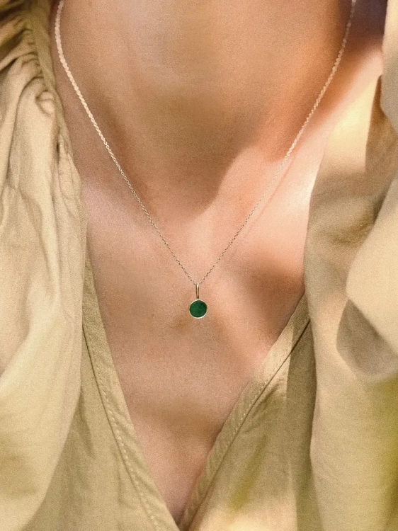 Short sterling silver necklace with natural green nephrite worn on neck