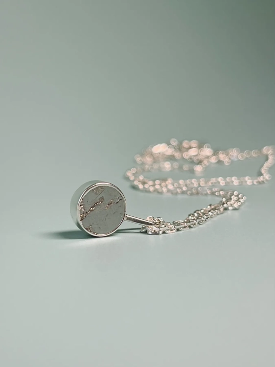 Minimalist meteorite pendant set in sterling silver – jewelry detail