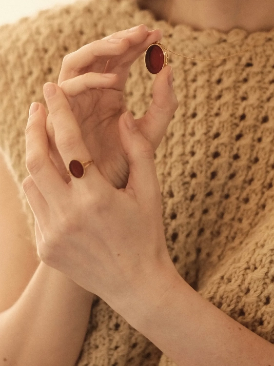 Personal gold locket with amber held in the hands
