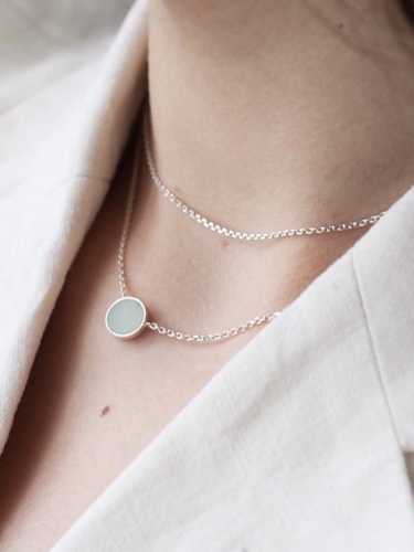Delicate silver necklace with chrysoprase stone styled for everyday wear