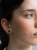 Gold hoop earrings with natural green nephrite stone worn by model – elegant minimalist jewelry