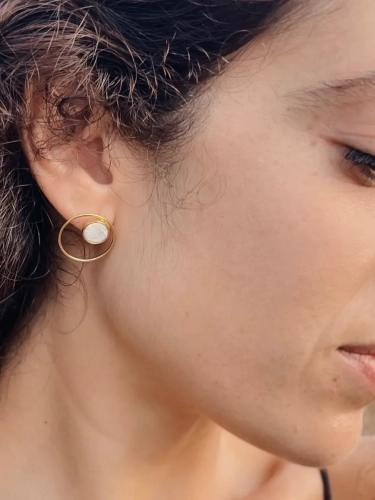 Gold circle earrings with natural white opal – elegant styling