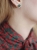 Gold stud earrings with Polish nephrite worn on ear