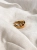 Gold-plated ear cuff with Baltic amber, close-up detail